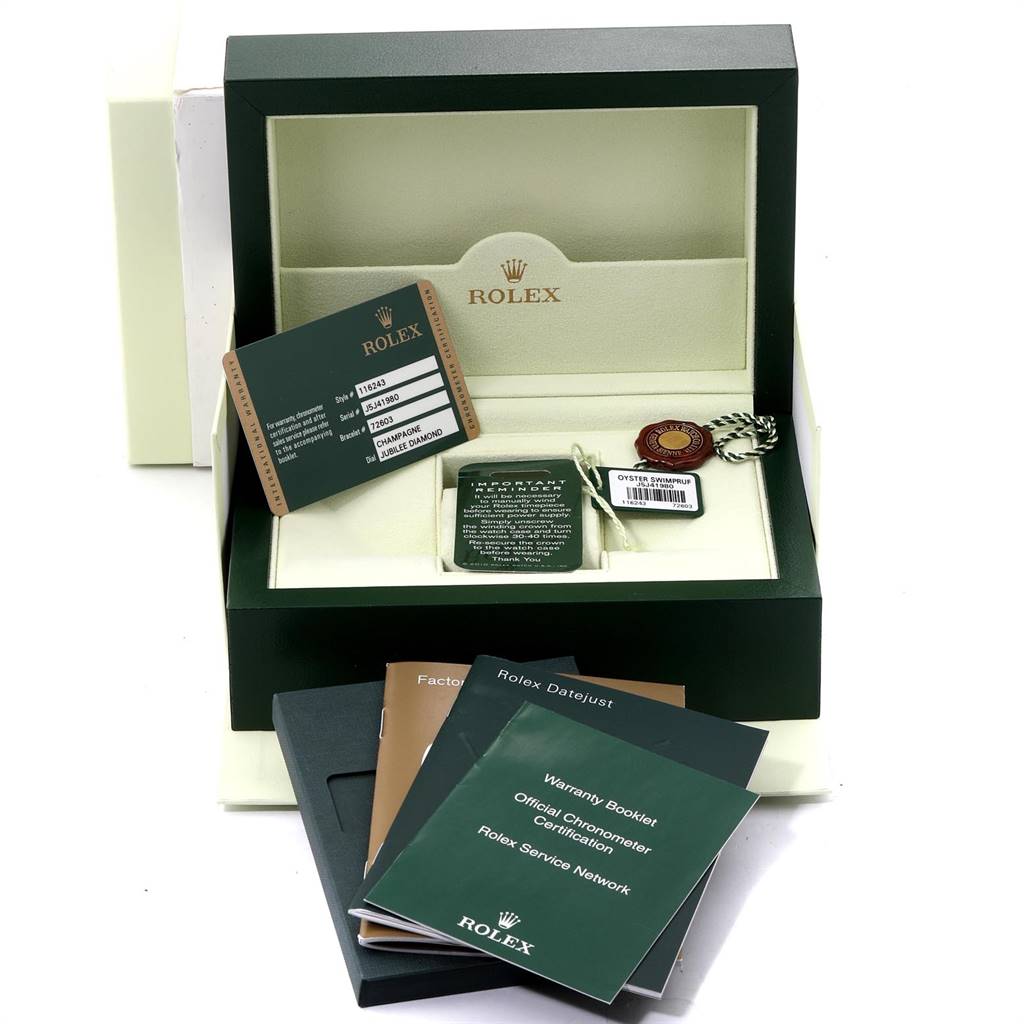 This is a high-angle shot showing the Rolex Datejust 116243 Men's Steel and Gold (two tone) Champagne Dial 116243 Men's Steel and Gold (two tone) Champagne Dial box, warranty cards, booklets, and accessory tags.