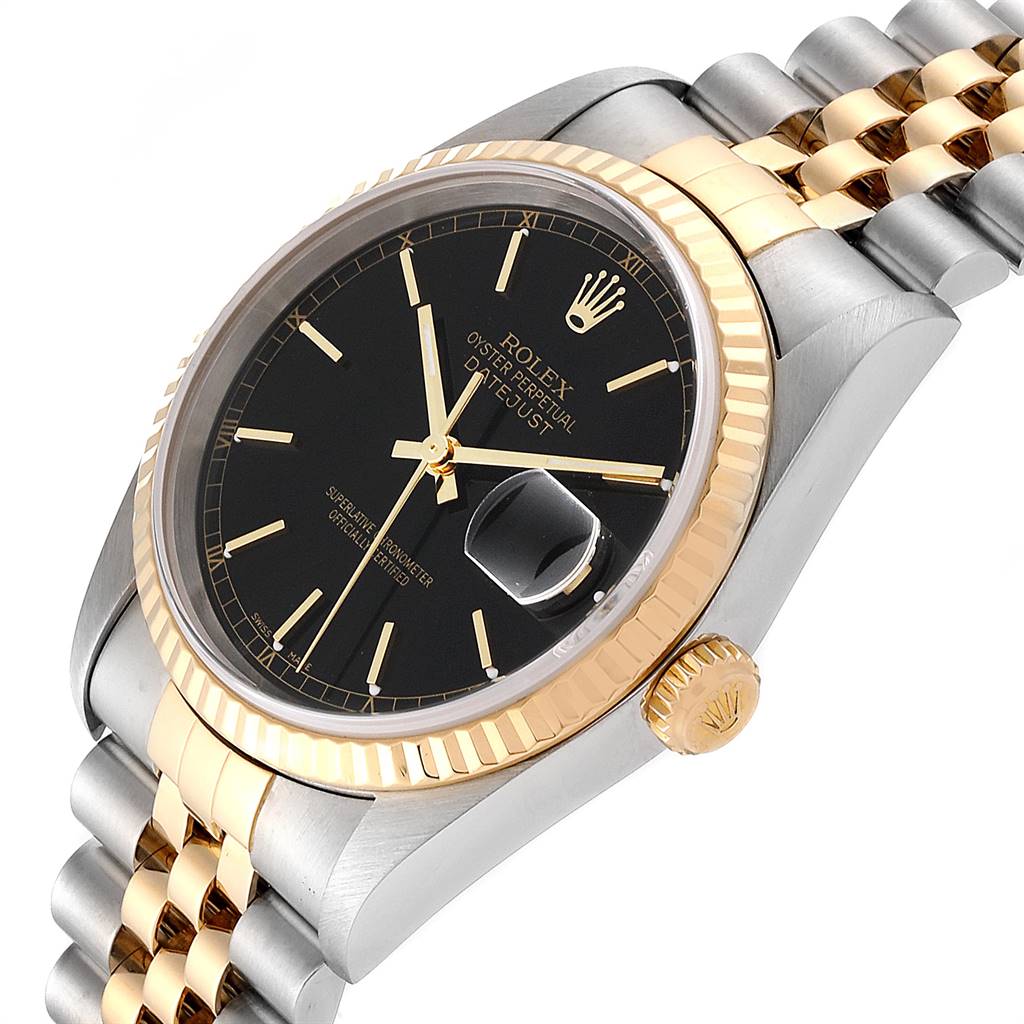 The image shows a Rolex Datejust 16233 Men
s Steel and Gold (two tone) Black Dial 16233 Men
s Steel and Gold (two tone) Black Dial watch at an angle showcasing its dial, fluted bezel, crown, and part of the Jubilee bracelet.