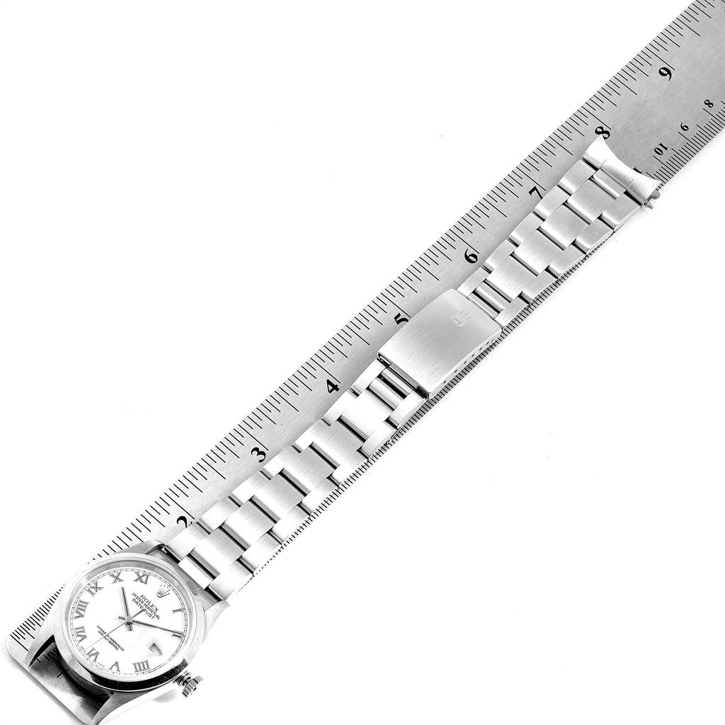 The image shows a Rolex Datejust 16200 Men's Stainless Steel White Dial 16200 Men's Stainless Steel White Dial watch and its bracelet, placed alongside a ruler for measurement.