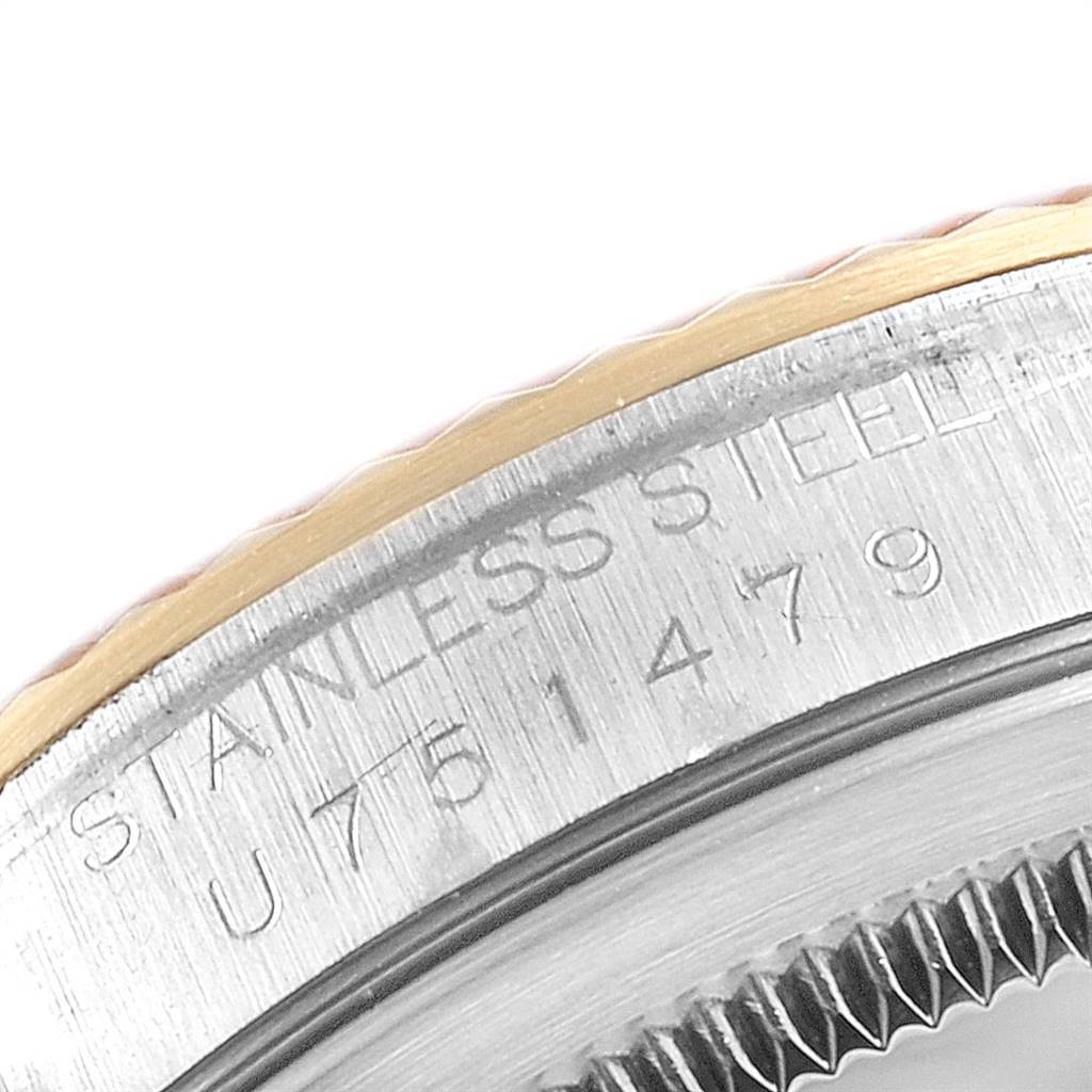 This close-up image shows the bezel and case back rim of the Rolex Datejust 16233 Men's Steel and Gold (two tone) White Dial 16233 Men's Steel and Gold (two tone) White Dial watch in stainless steel with an engraving visible.