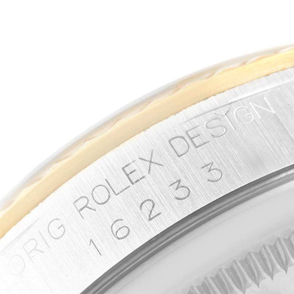 This image shows a close-up of the case side and bezel of a Rolex Datejust 16233 Men's Steel and Gold (two tone) White Dial 16233 Men's Steel and Gold (two tone) White Dial watch, with the model number and "ROLEX DESIGN" engraved.