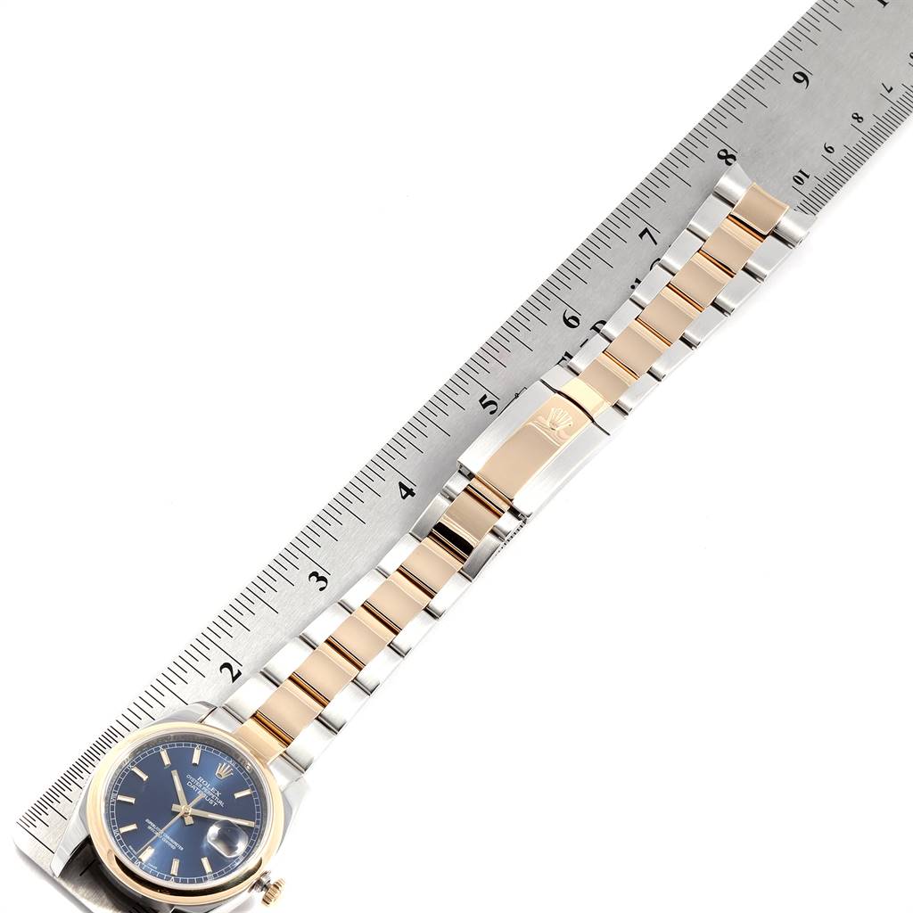 The image shows a top view of a Rolex Datejust 116203 Men
s Steel and Gold (two tone) Blue Dial 116203 Men
s Steel and Gold (two tone) Blue Dial watch, emphasizing its blue dial, bezel, and two-tone metal bracelet.