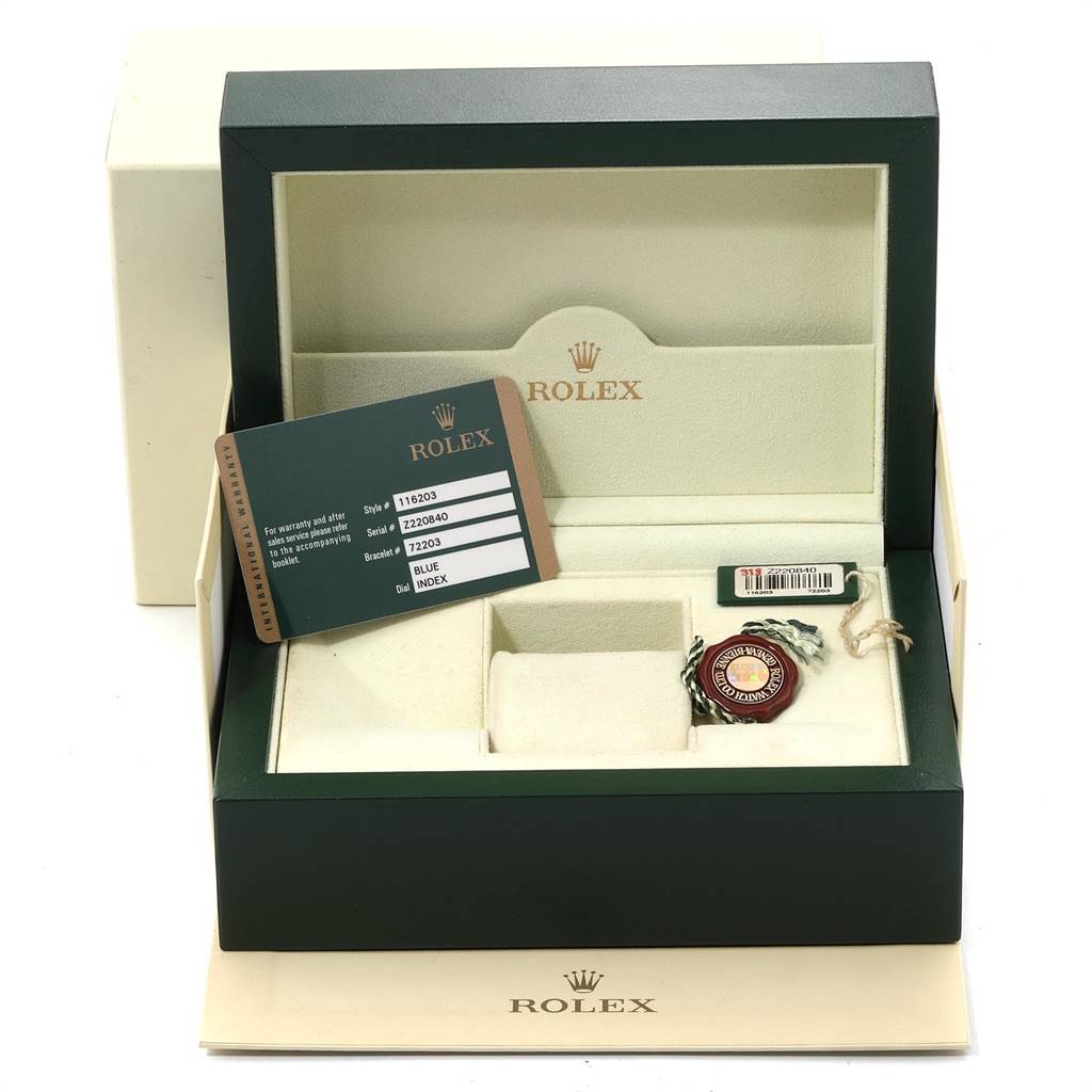 The image shows the open box of a Rolex Datejust 116203 Men
s Steel and Gold (two tone) Blue Dial 116203 Men
s Steel and Gold (two tone) Blue Dial watch, including a warranty card and tags, viewed from the front.