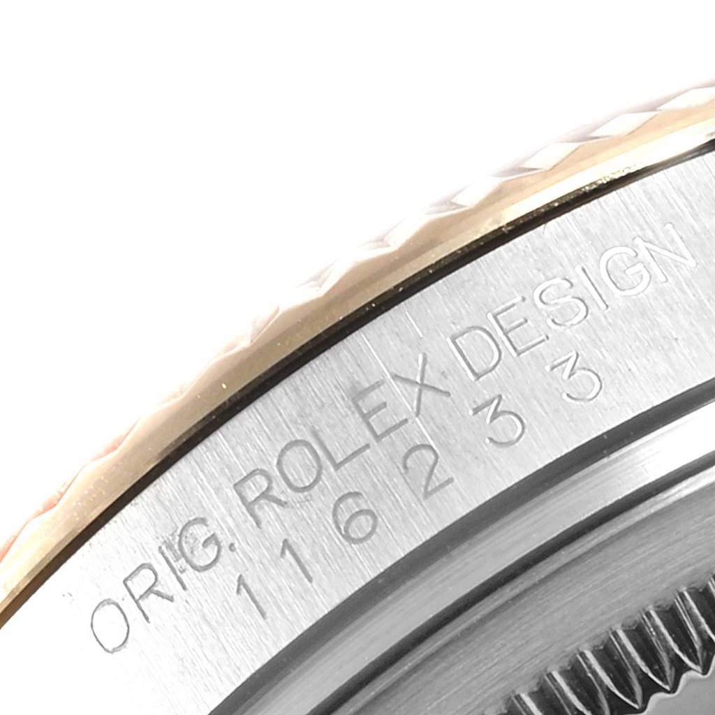 This image shows a close-up of the bezel and case side of the Rolex Datejust 116233 Men
s Stainless Steel Blue Dial 116233 Men
s Stainless Steel Blue Dial watch, highlighting the engraved text "ORIG. ROLEX DESIGN."