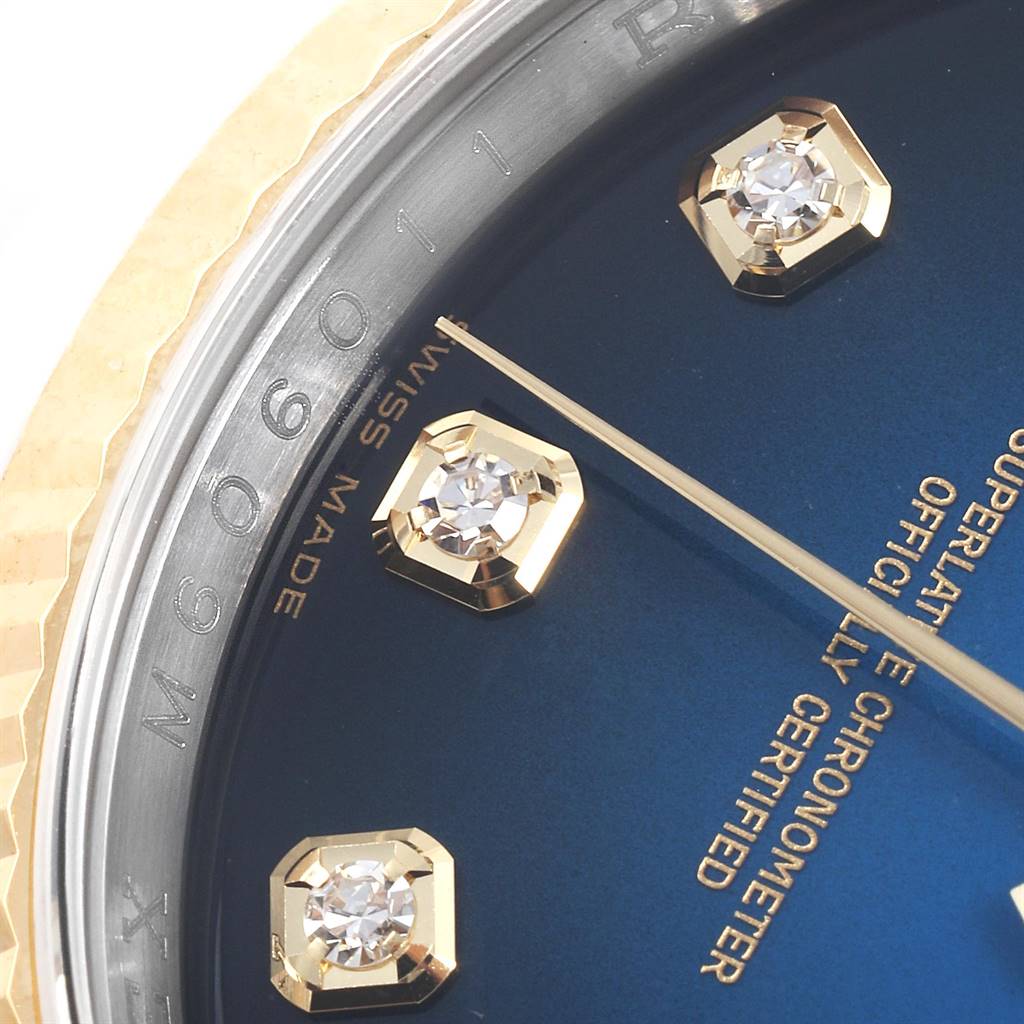 The image shows a partial close-up view of the dial and diamond-studded hour markers of a Rolex Datejust 116233 Men
s Stainless Steel Blue Dial 116233 Men
s Stainless Steel Blue Dial watch.