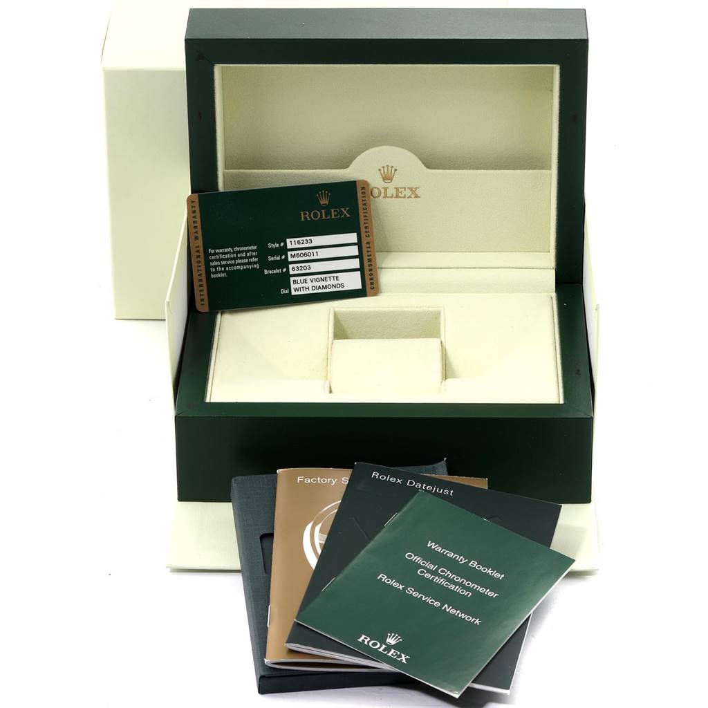 The image shows the open box and documents for a Rolex Datejust 116233 Men
s Stainless Steel Blue Dial 116233 Men
s Stainless Steel Blue Dial watch, displaying the warranty card and booklets.