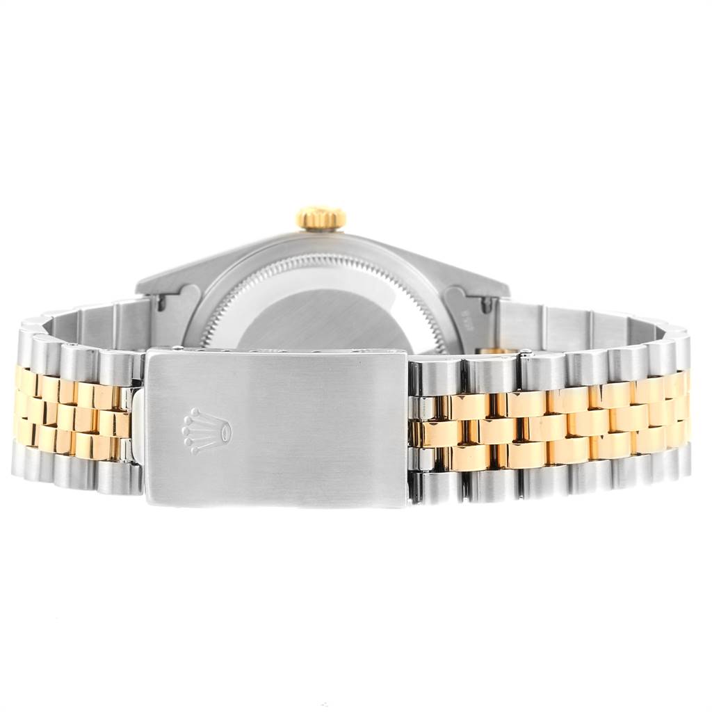 This back view of the Rolex Datejust 16233 Men's Steel and Gold (two tone) Silver Dial 16233 Men's Steel and Gold (two tone) Silver Dial watch displays the clasp, crown, and two-tone bracelet.