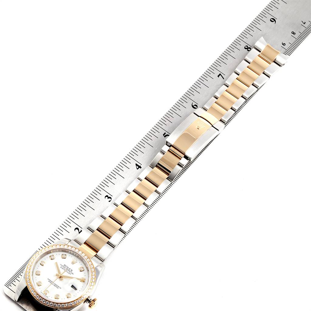 The image shows a Rolex Datejust 116243 Men's Stainless Steel White Dial 116243 Men's Stainless Steel White Dial watch laid flat with the dial, bracelet, and clasp visible along a ruler for measurement.