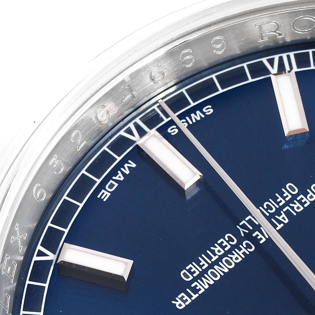 This close-up shot shows part of the dial and bezel of a Rolex Datejust 116200 Men
s Stainless Steel Blue Dial 116200 Men
s Stainless Steel Blue Dial watch, featuring hour markers and text detail.