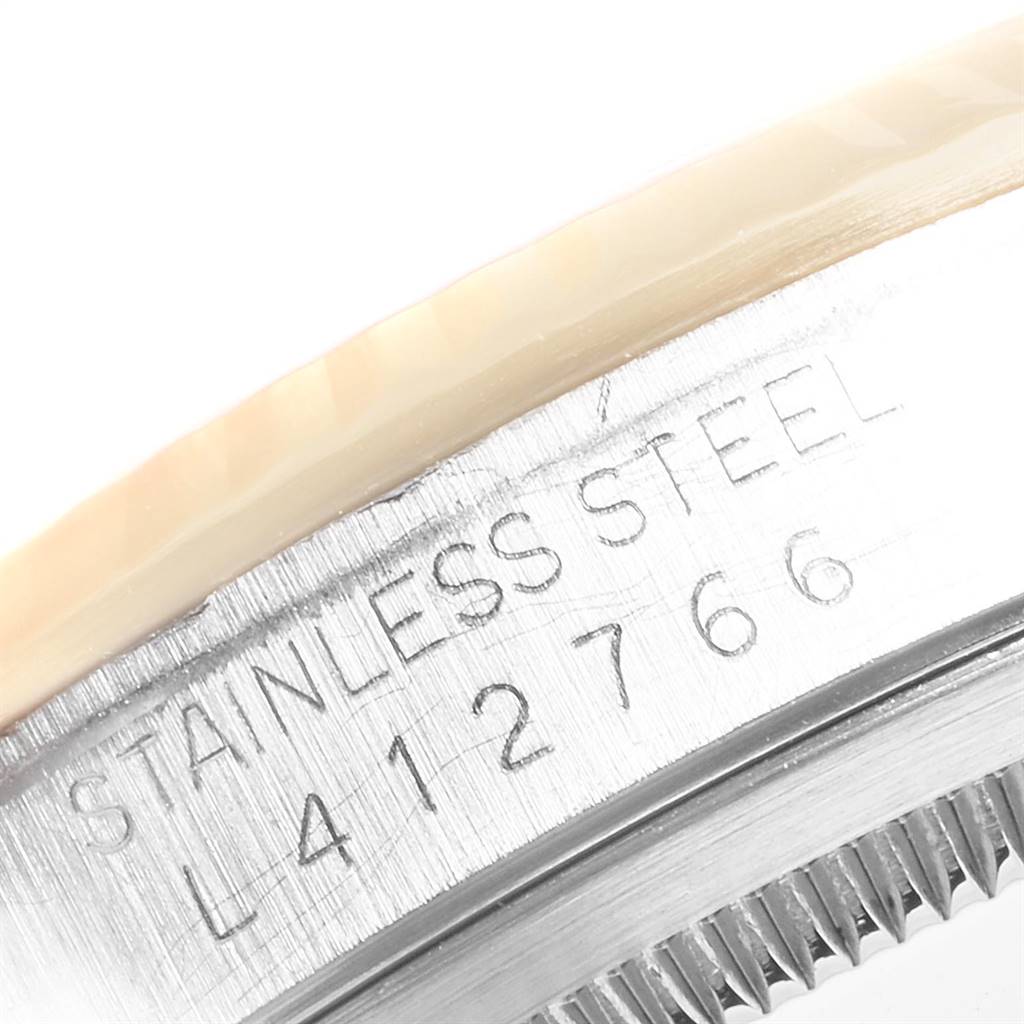 The image shows a close-up of the stainless steel case and serial number engraving of a Rolex Datejust 16233 Men
s Steel and Gold (two tone) Blue Dial 16233 Men
s Steel and Gold (two tone) Blue Dial watch.