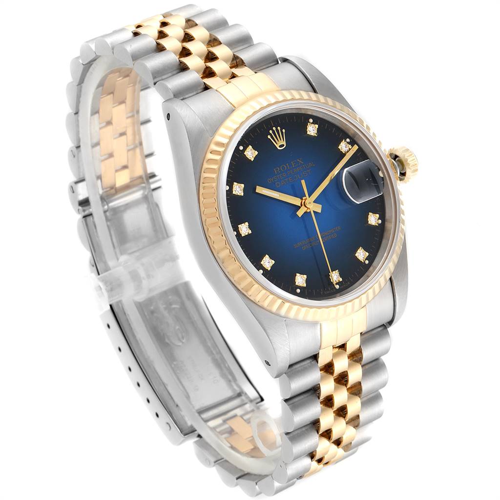 This image shows the Rolex Datejust 16233 Men
s Steel and Gold (two tone) Blue Dial 16233 Men
s Steel and Gold (two tone) Blue Dial watch at a three-quarter angle, displaying its face, bezel, and two-tone bracelet.