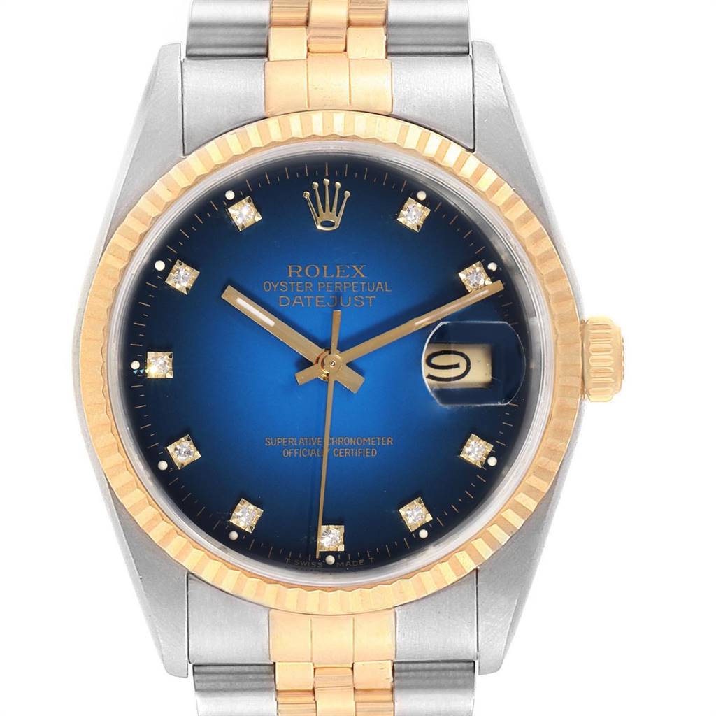 This is a close-up view of the Rolex Datejust 16233 Men
s Steel and Gold (two tone) Blue Dial 16233 Men
s Steel and Gold (two tone) Blue Dial watch, showing the face, fluted bezel, and part of the bracelet.