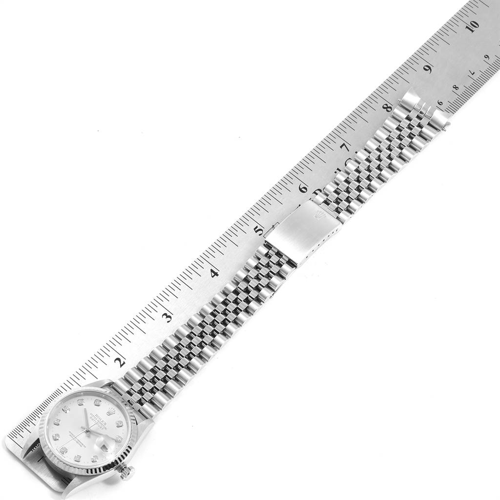 The image shows a top-down view of a Rolex Datejust 16234 Men's Stainless Steel Silver Dial 16234 Men's Stainless Steel Silver Dial watch with the band laid out beside a ruler for measurement.