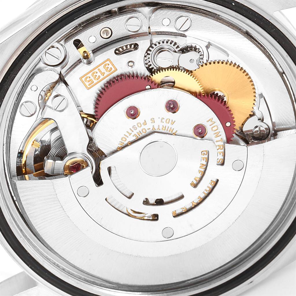 The image shows a close-up of the movement mechanism inside a Rolex Datejust 16234 Men's Stainless Steel Silver Dial 16234 Men's Stainless Steel Silver Dial watch, highlighting gears and intricate components.
