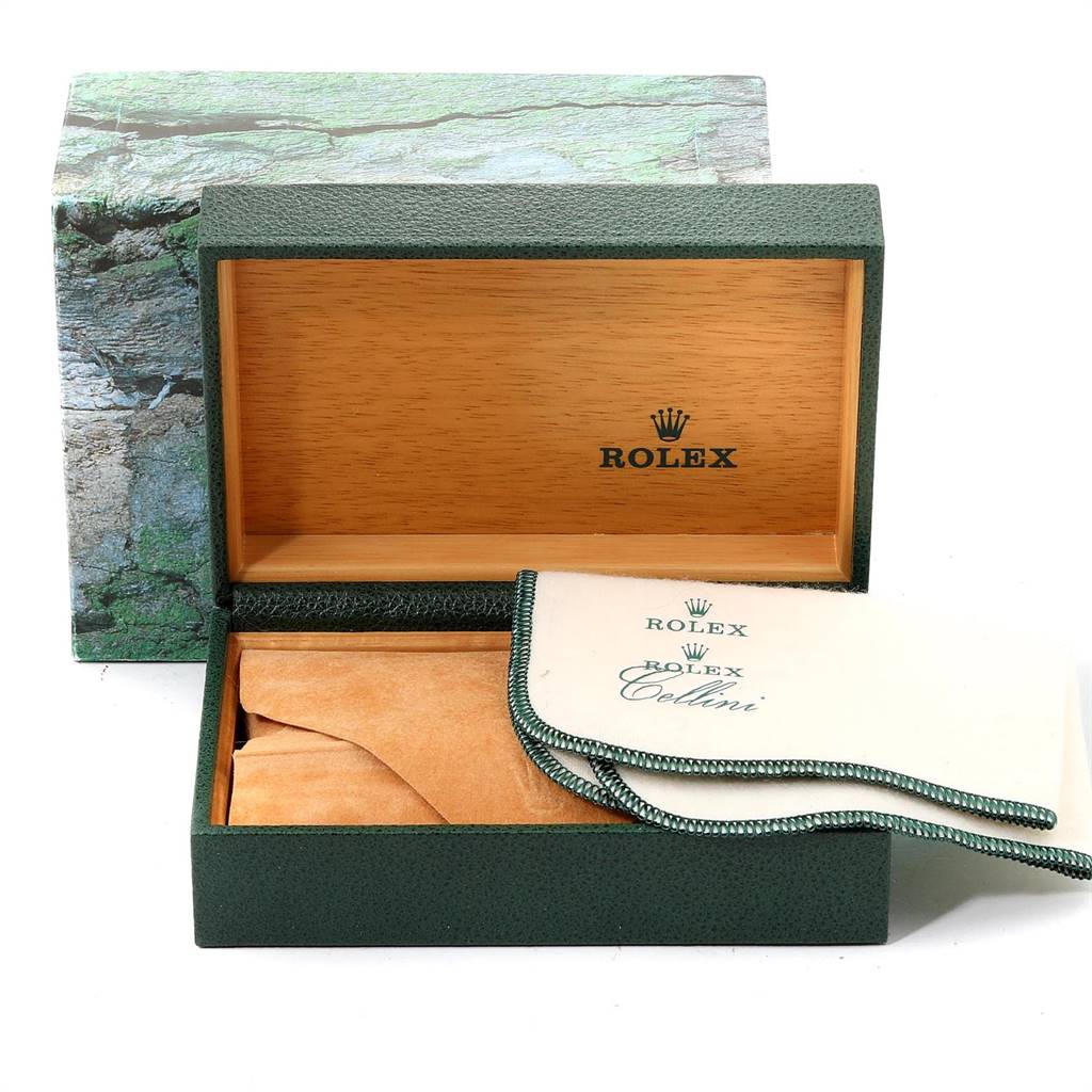 This image shows an open Rolex box with branded cloths and packaging, presumably for the Datejust model.