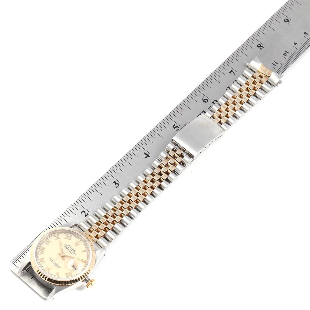 The image shows a Rolex Datejust 16233 Men's Steel and Gold (two tone) Beige Dial 16233 Men's Steel and Gold (two tone) Beige Dial watch laid flat, displaying the face, gold/silver bracelet, and clasp next to a measuring ruler.