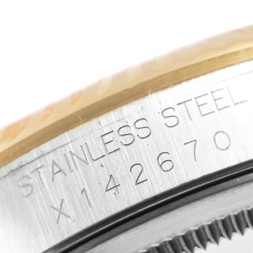 This close-up image shows the serial number and "Stainless Steel" engraving on the side of a Rolex Datejust 16233 Men's Steel and Gold (two tone) Beige Dial 16233 Men's Steel and Gold (two tone) Beige Dial watch case.