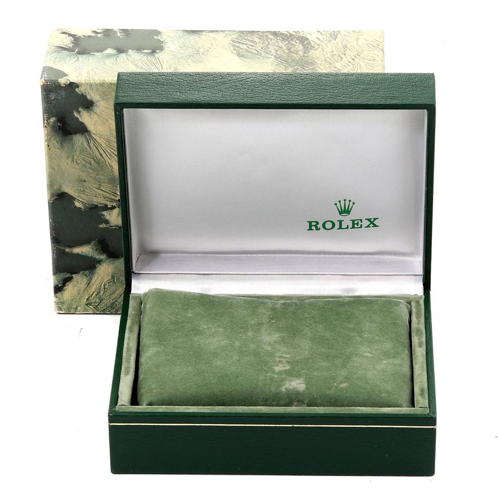 Shown is an open green Rolex watch box, presumably for a Datejust model, with a cushion and the Rolex logo.