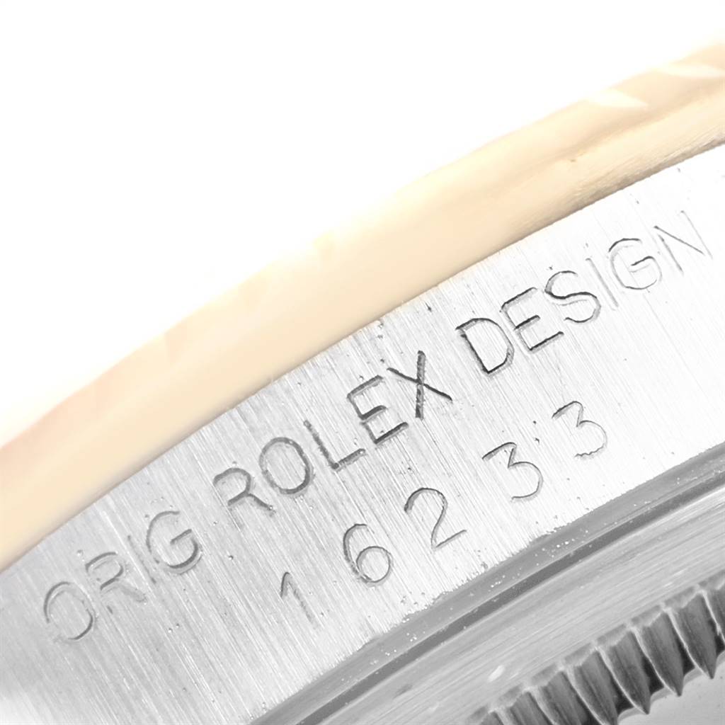 The image shows a close-up of the engraved serial number and design marking on the case of a Rolex Datejust 16233 Men's Steel and Gold (two tone) Champagne Dial 16233 Men's Steel and Gold (two tone) Champagne Dial watch.