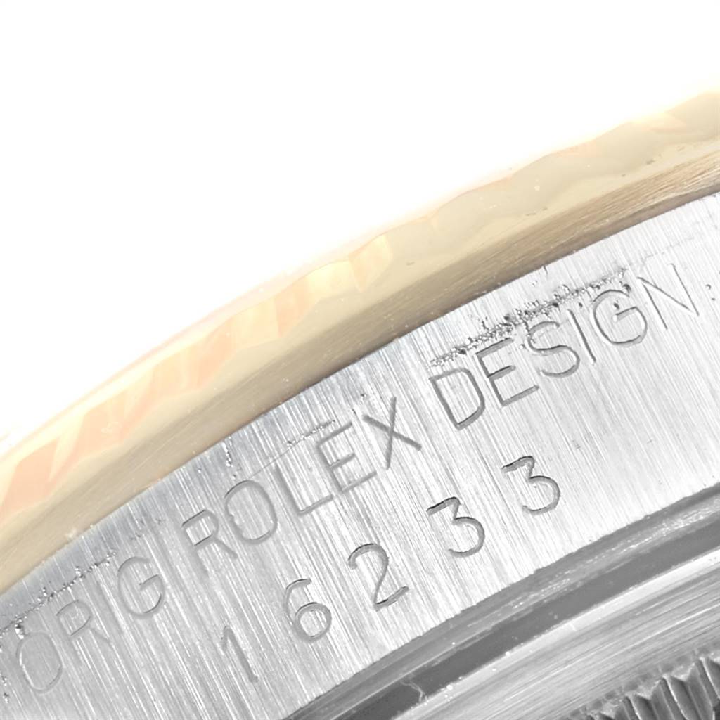 This image shows a close-up of the engraved edge on the bezel of a Rolex Datejust 16233 Men's Steel and Gold (two tone) Champagne Dial 16233 Men's Steel and Gold (two tone) Champagne Dial watch.