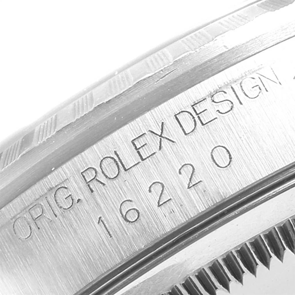 This image shows a close-up of the Rolex Datejust 16220 Men's Stainless Steel Silver Dial 16220 Men's Stainless Steel Silver Dial model 16220 case with "ORIG. ROLEX DESIGN" engraving.