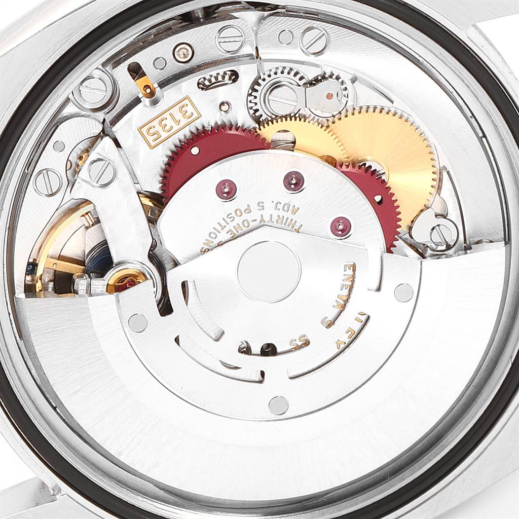 The image shows an internal view of the Rolex Datejust 116234 Men's Stainless Steel Black Dial 116234 Men's Stainless Steel Black Dial watch movement with various gears and mechanisms visible.