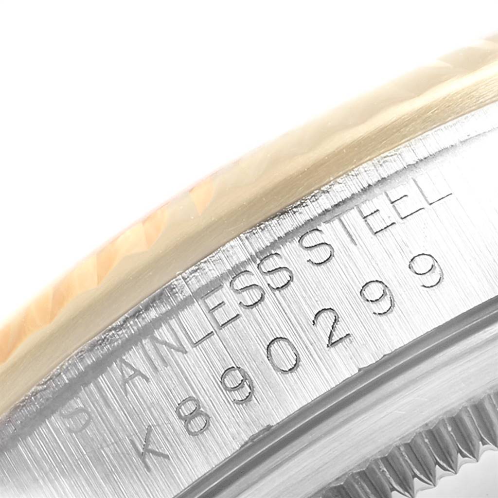 The image shows a close-up of the serial number engraved on the side of a Rolex Datejust 16233 Men's Steel and Gold (two tone) Champagne Dial 16233 Men's Steel and Gold (two tone) Champagne Dial model watch bezel.