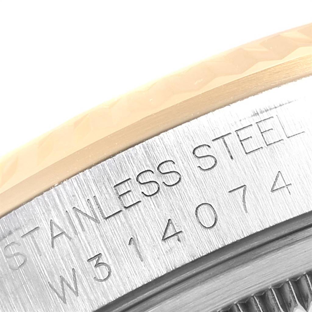 The image shows a close-up of the bezel and case back of a Rolex Datejust 16233 Men's Steel and Gold (two tone) Champagne Dial 16233 Men's Steel and Gold (two tone) Champagne Dial, displaying the serial number and "STAINLESS STEEL" engraving.