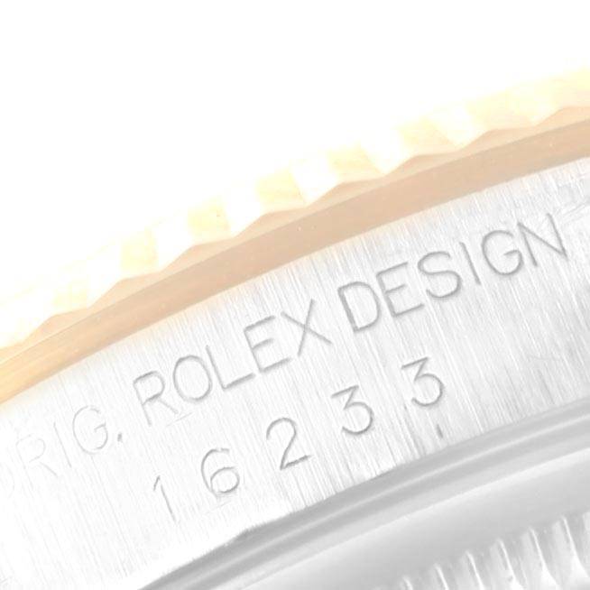 The image shows a close-up of the engraved text on the case of a Rolex Datejust 16233 Men's Steel and Gold (two tone) Champagne Dial 16233 Men's Steel and Gold (two tone) Champagne Dial watch.