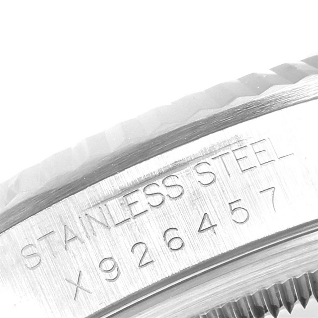 This close-up image shows the side of the stainless steel case of a Rolex Datejust 16234 Men's Stainless Steel White Dial 16234 Men's Stainless Steel White Dial model with serial numbers.