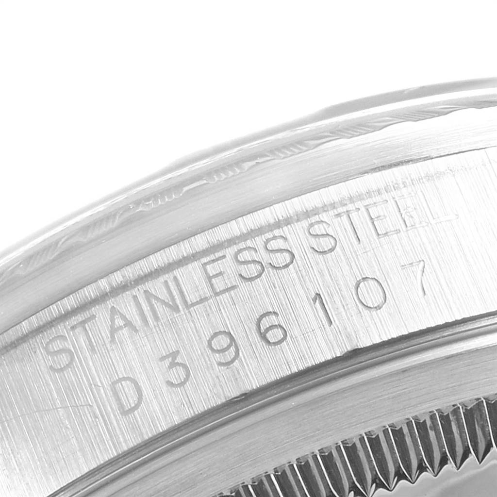 This image shows a close-up of the stainless steel casing and serial number of a Rolex Datejust 16220 Men's Stainless Steel Black Dial 16220 Men's Stainless Steel Black Dial watch.
