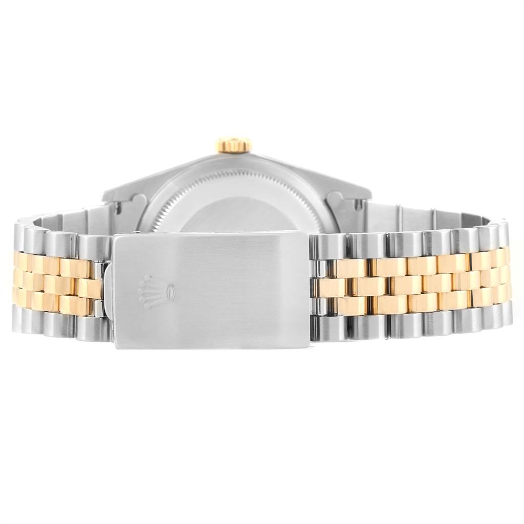 The image shows the back of a Rolex Datejust 16233 Men
s Steel and Gold (two tone) Champagne Dial 16233 Men
s Steel and Gold (two tone) Champagne Dial watch, focusing on the two-tone jubilee bracelet and the clasp.
