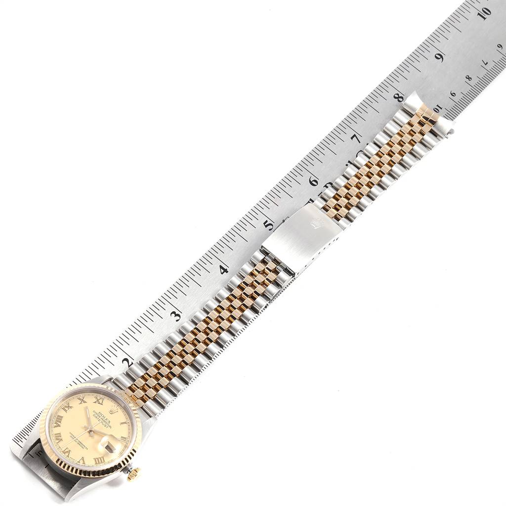 The image shows a Rolex Datejust 16233 Men's Steel and Gold (two tone) Champagne Dial 16233 Men's Steel and Gold (two tone) Champagne Dial watch laid flat with the face and jubilee bracelet fully visible against a ruler for measurement.