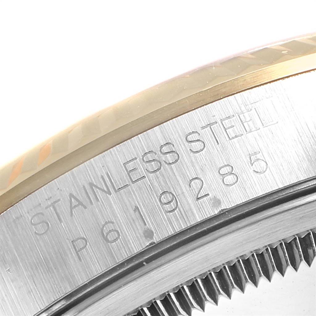 The image shows a close-up of the side of the stainless steel casing with engraved details and the edge of the bezel of a Rolex Datejust 16233 Men's Steel and Gold (two tone) Blue Dial 16233 Men's Steel and Gold (two tone) Blue Dial watch.