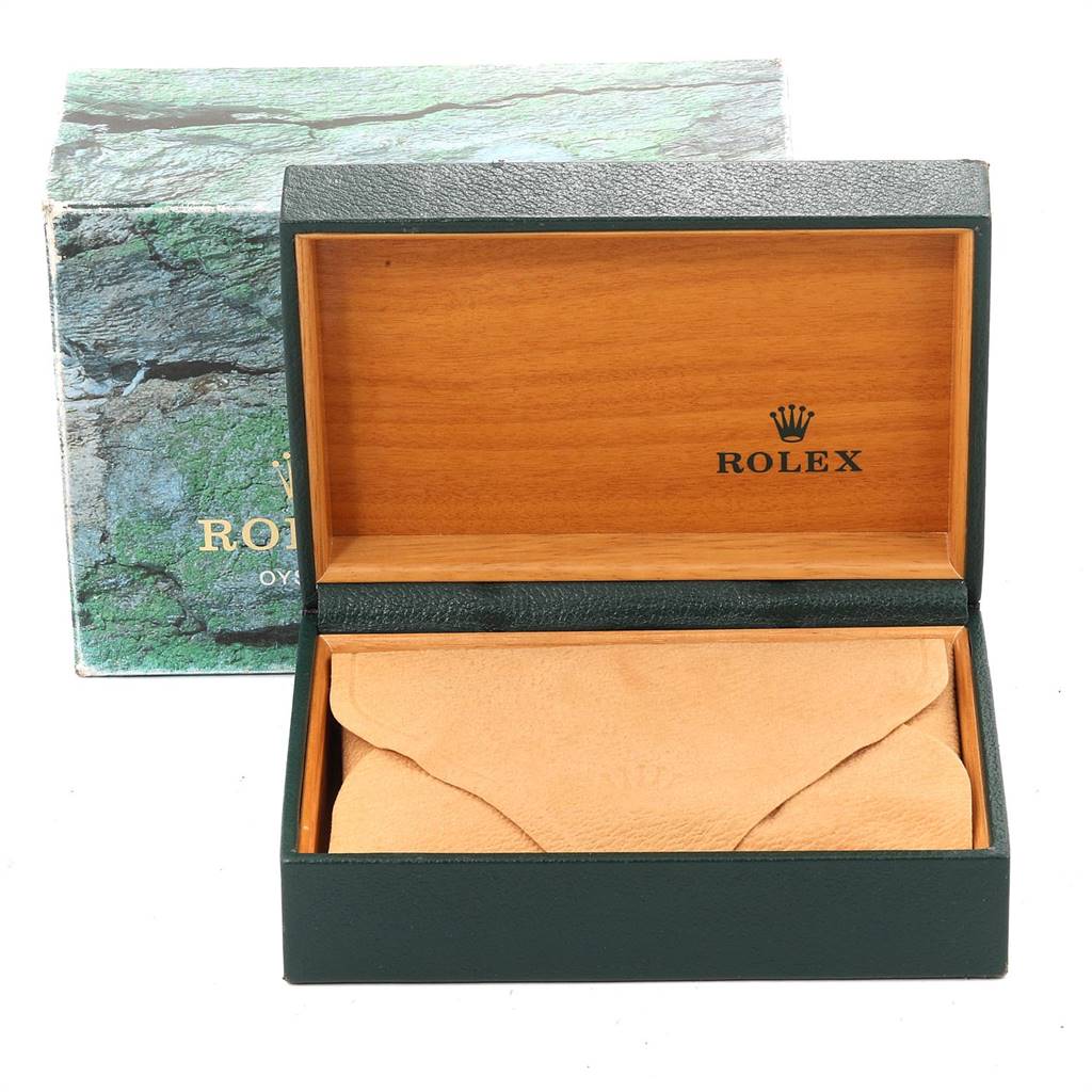 This image shows an open Rolex Datejust 16233 Men's Steel and Gold (two tone) Blue Dial 16233 Men's Steel and Gold (two tone) Blue Dial watch box and cushion, with the brand's logo visible inside the lid.