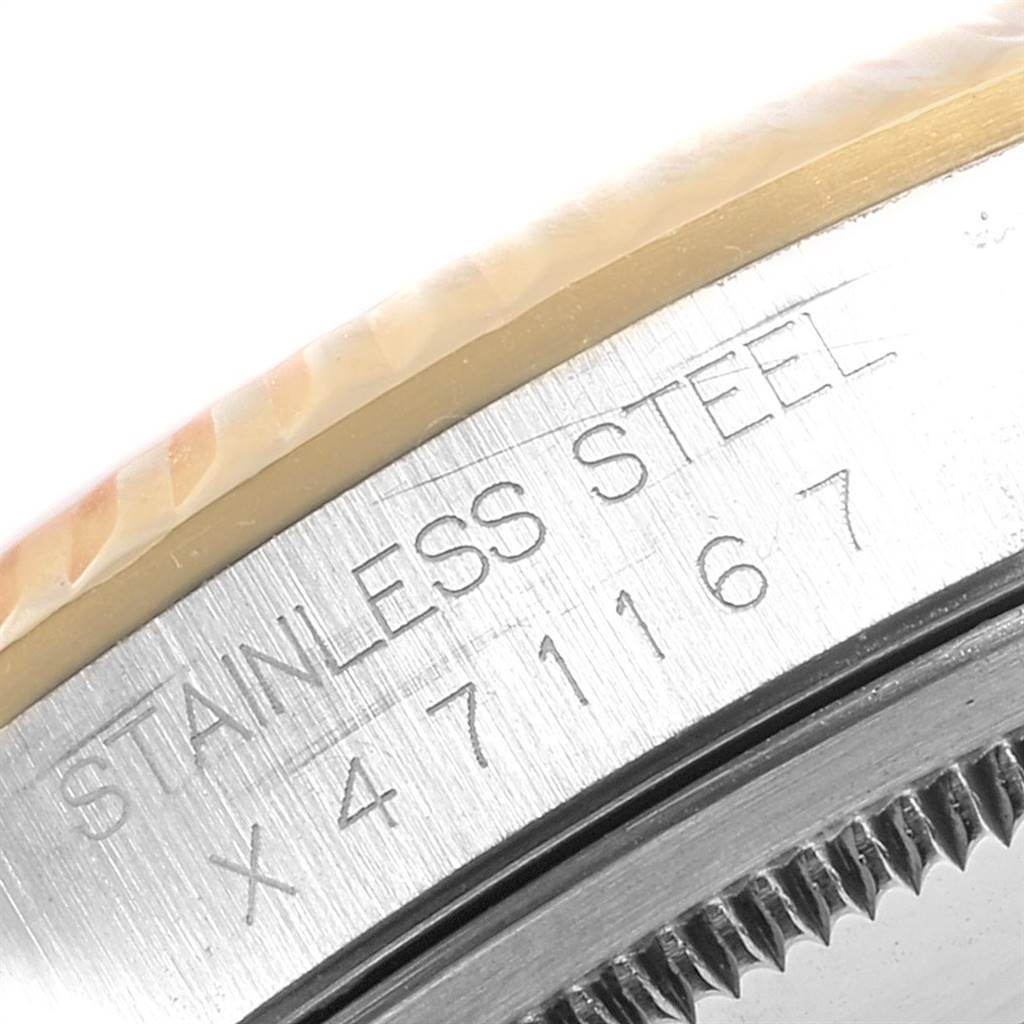 This close-up image shows the bezel and case side of a Rolex Datejust 16233 Men
s Steel and Gold (two tone) Black Dial 16233 Men
s Steel and Gold (two tone) Black Dial model, focusing on the stainless steel engraving and serial number.