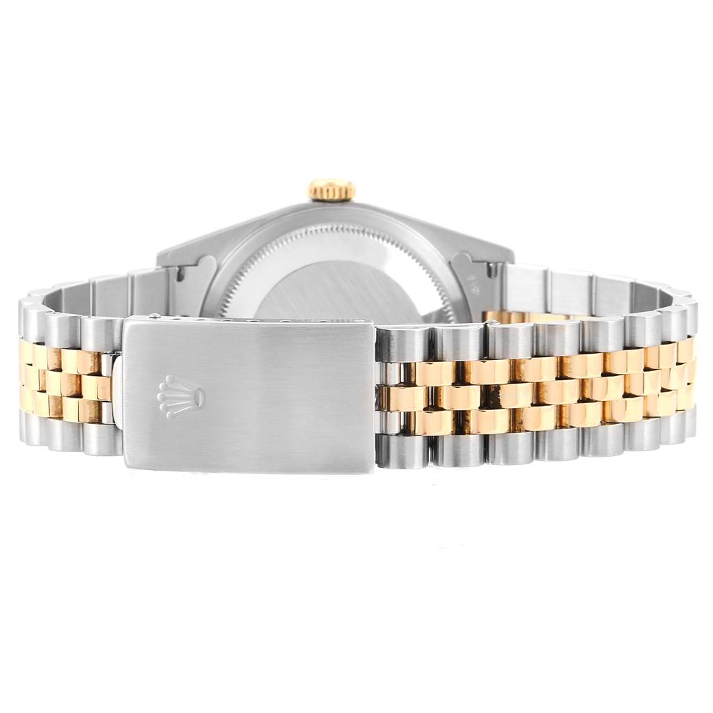 This image shows the clasp, bracelet, and case back of a Rolex Datejust 16233 Men's Steel and Gold (two tone) Champagne Dial 16233 Men's Steel and Gold (two tone) Champagne Dial watch from a rear view.