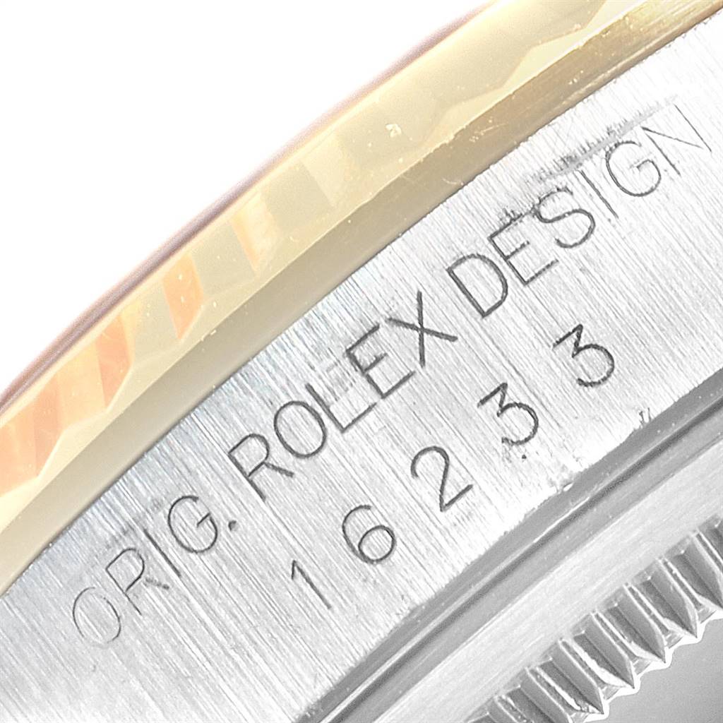 This image shows a close-up of the serial number on the side of a Rolex Datejust 16233 Men's Steel and Gold (two tone) Champagne Dial 16233 Men's Steel and Gold (two tone) Champagne Dial watch.