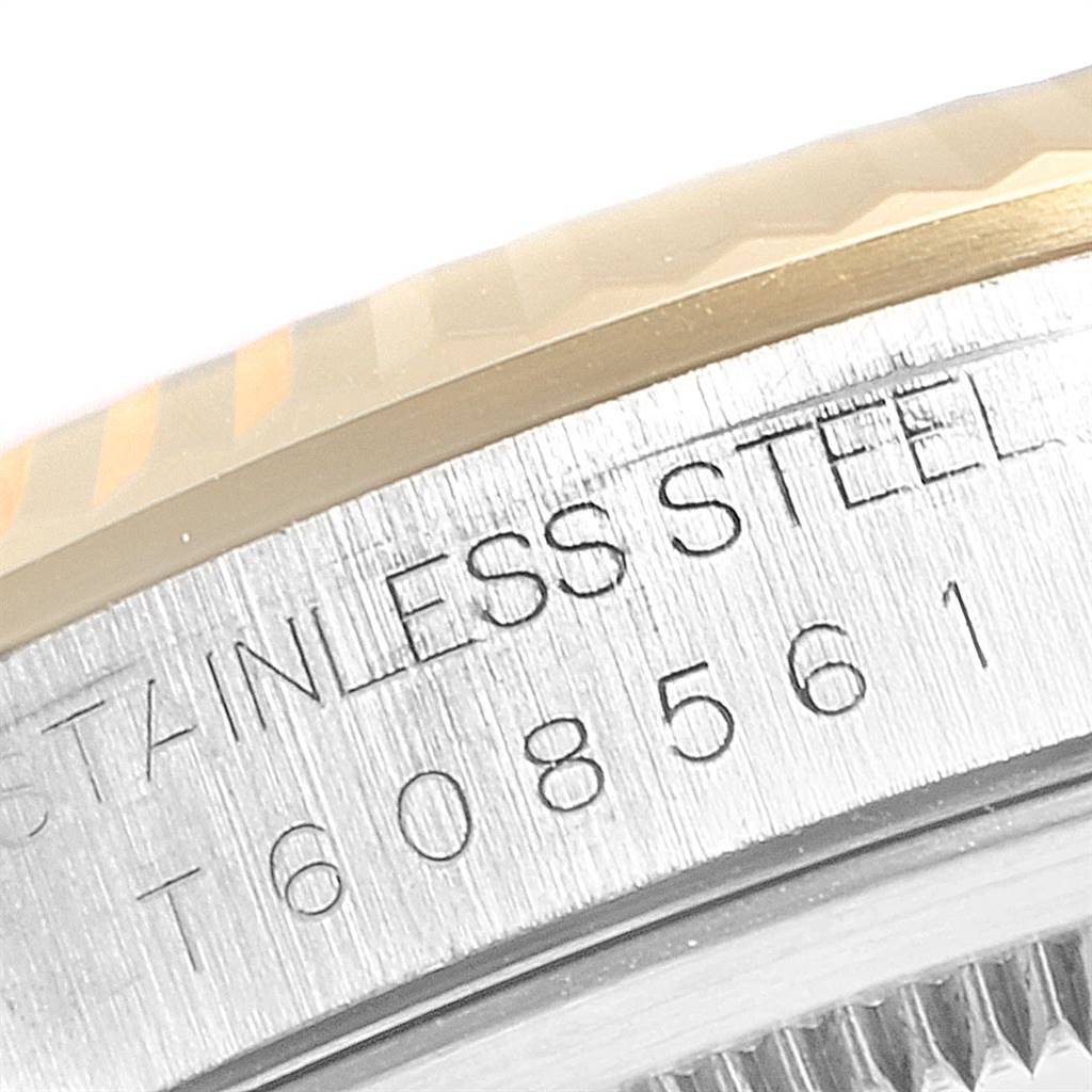 The image shows a close-up of the engraved rim and fluted bezel of a Rolex Datejust 16233 Men's Steel and Gold (two tone) Champagne Dial 16233 Men's Steel and Gold (two tone) Champagne Dial watch.