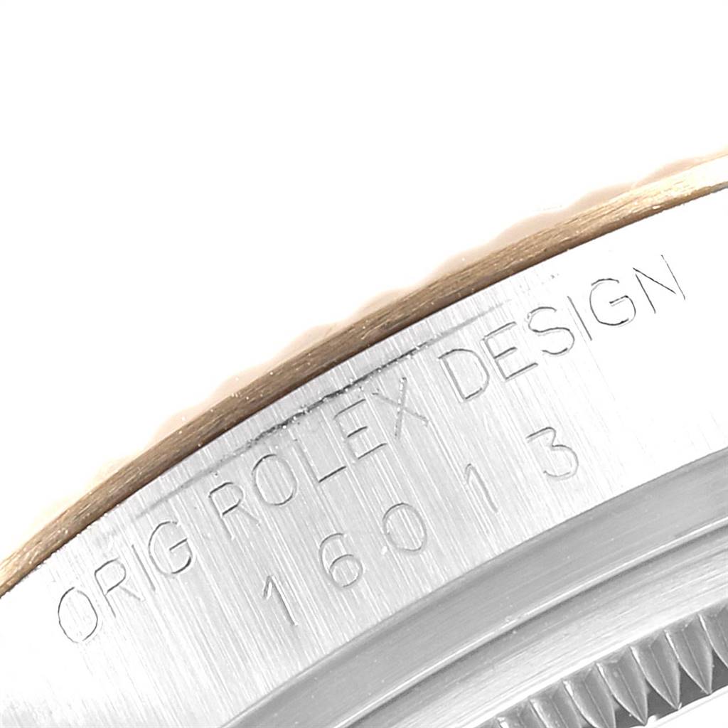 This image shows a close-up of the case edge and serial number of a Rolex Datejust 16013 Men's Stainless Steel Champagne Dial 16013 Men's Stainless Steel Champagne Dial model, revealing the "ROLEX DESIGN" engraving.