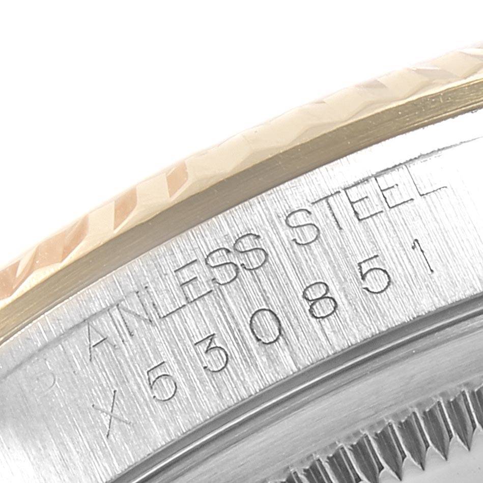 The image shows a close-up of the side of a Rolex Datejust 16233 Men's Steel and Gold (two tone) White Dial 16233 Men's Steel and Gold (two tone) White Dial watch, highlighting the fluted bezel and engraved serial number.
