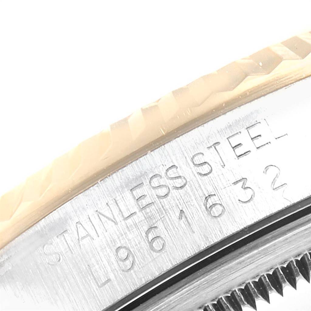 The image shows an angled close-up of the bezel and case engraved with "STAINLESS STEEL" of the Rolex Datejust 16233 Men's Steel and Gold (two tone) Black Dial 16233 Men's Steel and Gold (two tone) Black Dial watch.