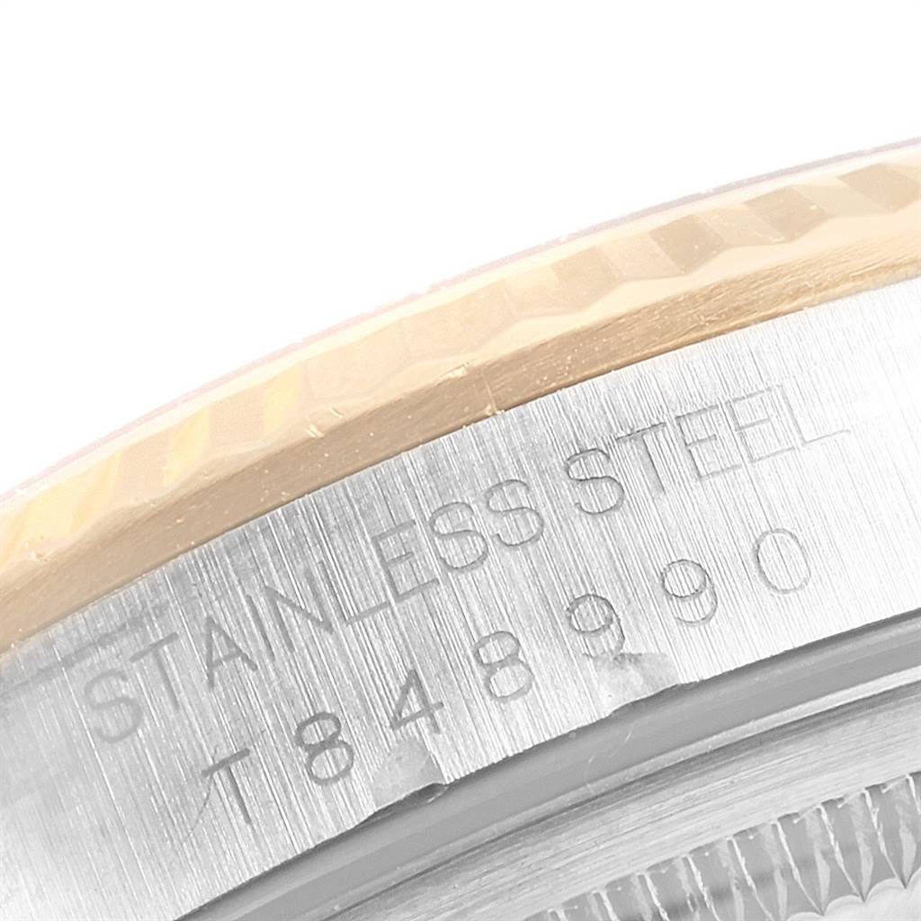 This image shows a close-up of the engraved case back of a Rolex Datejust 16233 Men's Steel and Gold (two tone) White Dial 16233 Men's Steel and Gold (two tone) White Dial, highlighting the serial number and stainless steel material.