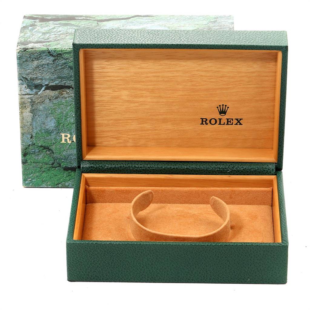 The image shows an open leather and wood Rolex box for the Datejust model, showcasing the inner padding and holder.