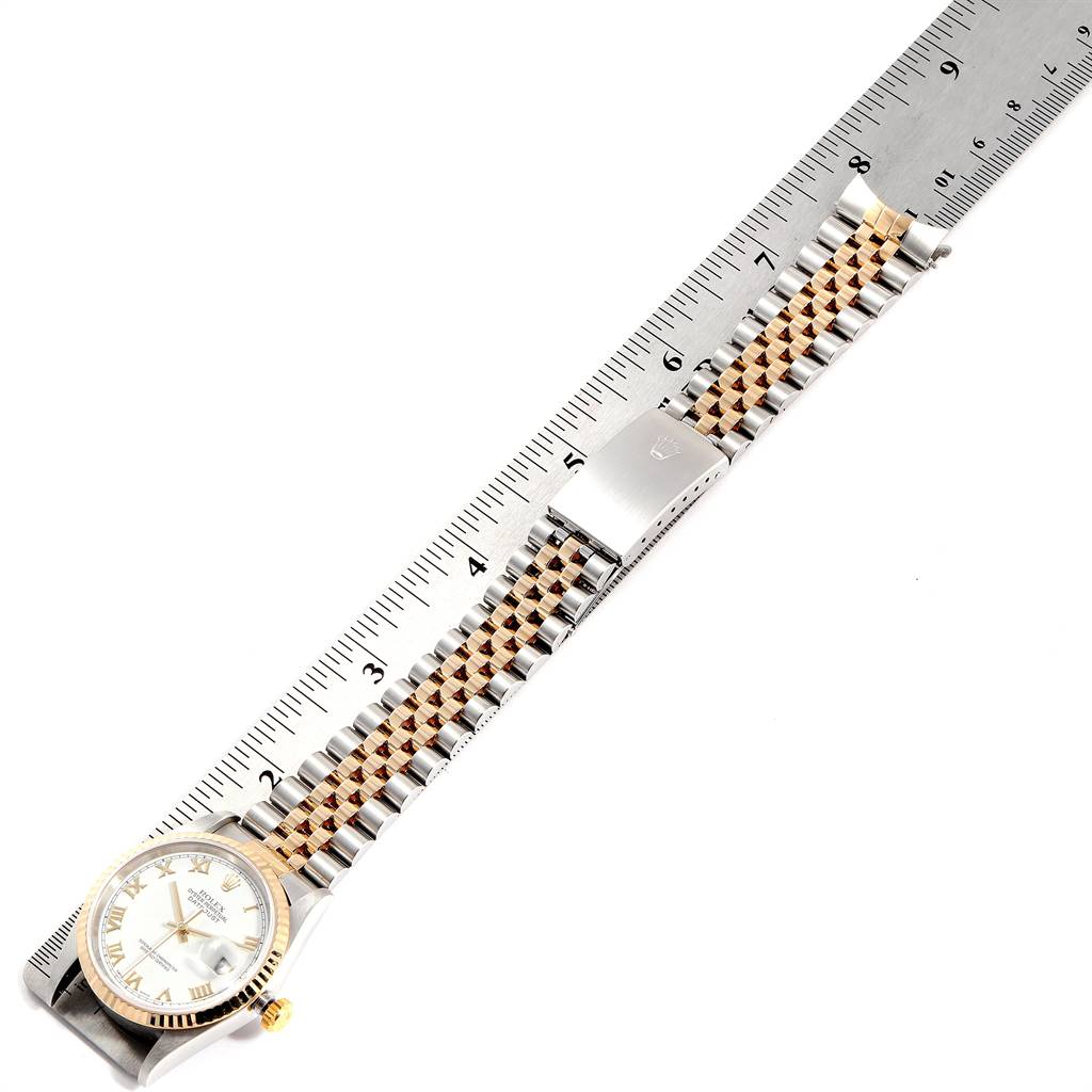 The image shows a Rolex Datejust 16233 Men's Steel and Gold (two tone) White Dial 16233 Men's Steel and Gold (two tone) White Dial watch and its bracelet laid flat next to a ruler for measurement.