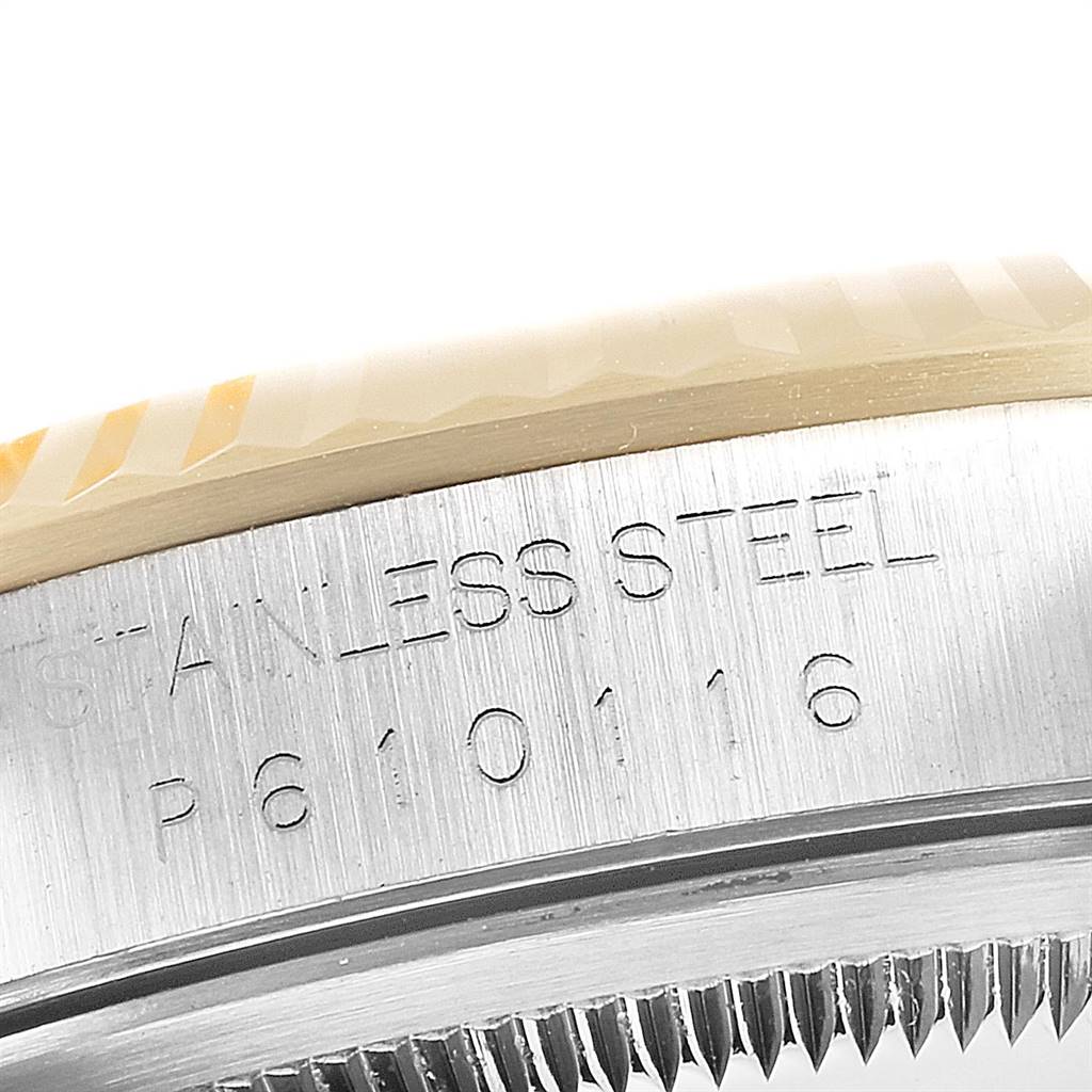 This close-up image shows the side engraving and edge of the bezel and casing of a Rolex Datejust 16233 Men's Steel and Gold (two tone) White Dial 16233 Men's Steel and Gold (two tone) White Dial model watch.