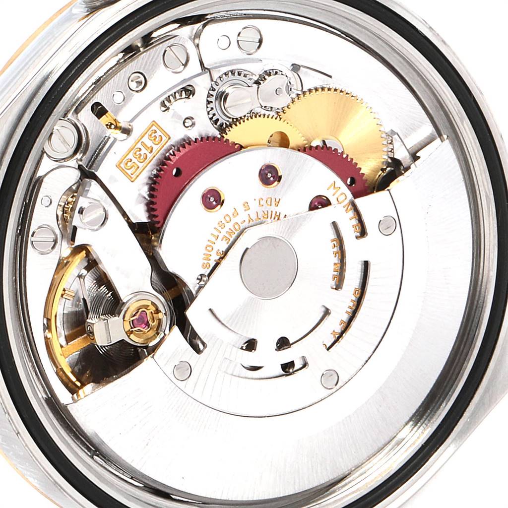 The image shows an internal view of a Rolex Datejust 16233 Men's Steel and Gold (two tone) White Dial 16233 Men's Steel and Gold (two tone) White Dial watch movement, including gears, rotors, and other intricate components.