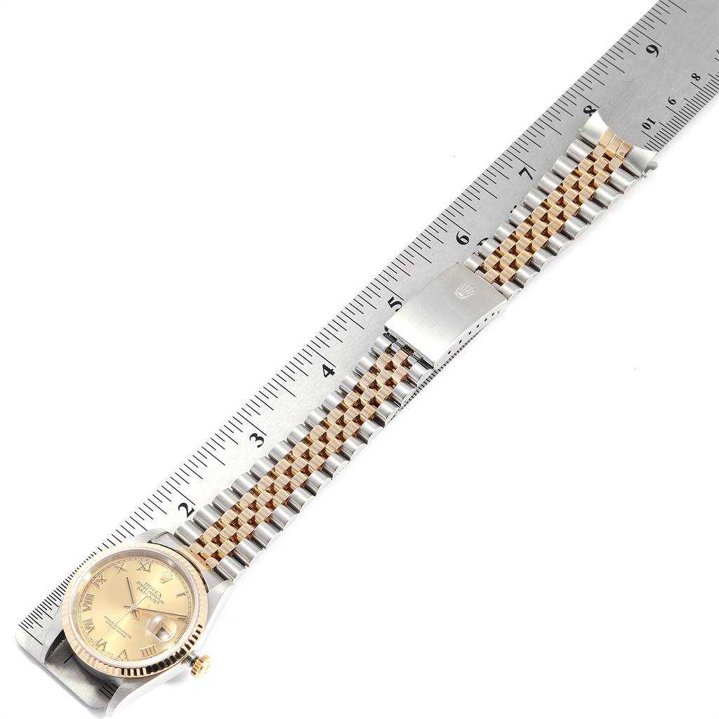 The image shows a Rolex Datejust 16233 Men
s Steel and Gold (two tone) Champagne Dial 16233 Men
s Steel and Gold (two tone) Champagne Dial watch lying flat, with a ruler beside it, displaying the face, bezel, and bracelet.