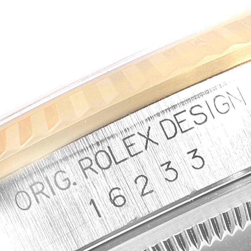 Close-up of a Rolex Datejust 16233 Men
s Steel and Gold (two tone) Champagne Dial 16233 Men
s Steel and Gold (two tone) Champagne Dial watch, showing the model number "16233" and "ORIG. ROLEX DESIGN" engraving.