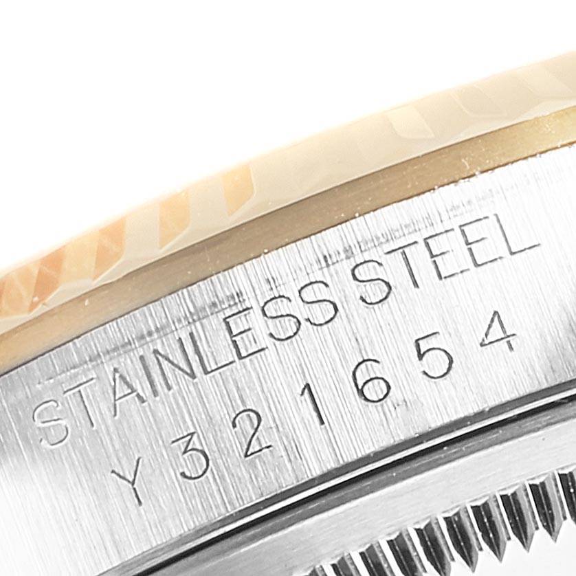 This close-up shows the engravings and part of the bezel of a Rolex Datejust 16233 Men
s Steel and Gold (two tone) Champagne Dial 16233 Men
s Steel and Gold (two tone) Champagne Dial watch, highlighting the "Stainless Steel" text and serial number.